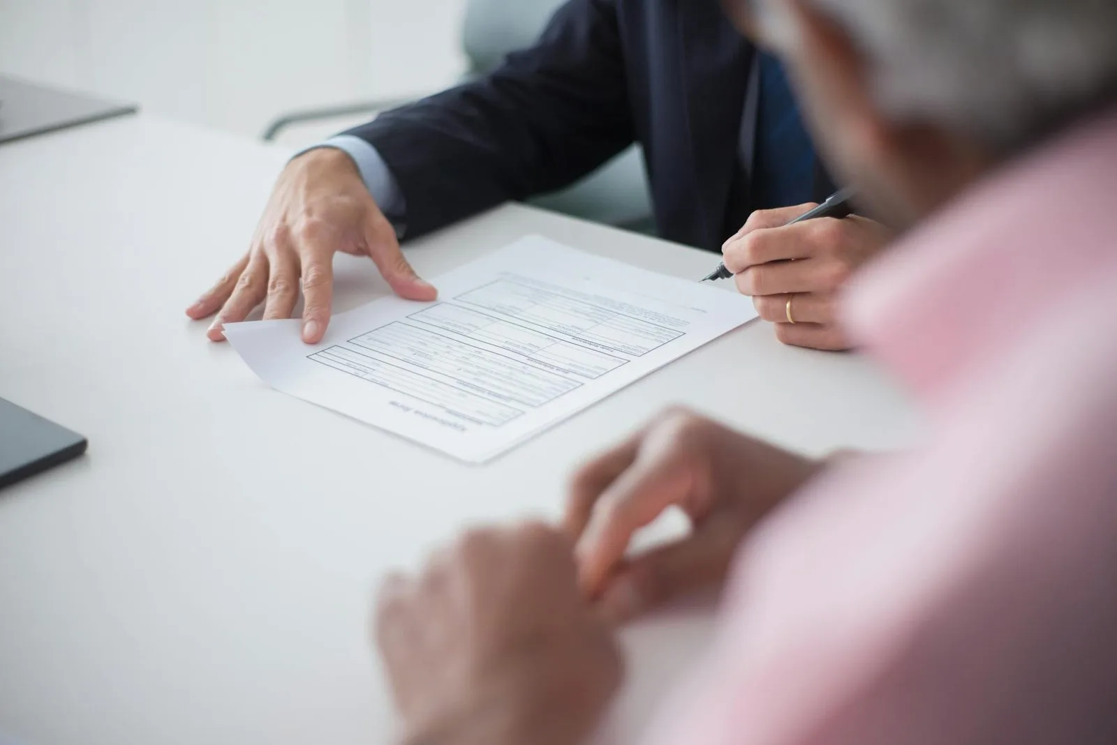 Hotel team reviewing cost and revenue figures together at a table
